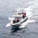 Emory S. Land conducts boat operations while anchored in Andaman Sea