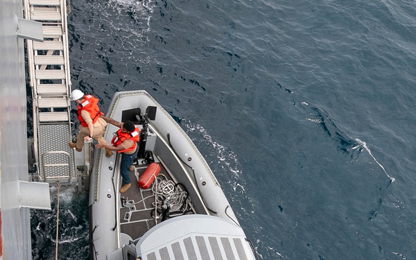 Emory S. Land conducts boat operations while anchored in Andaman Sea