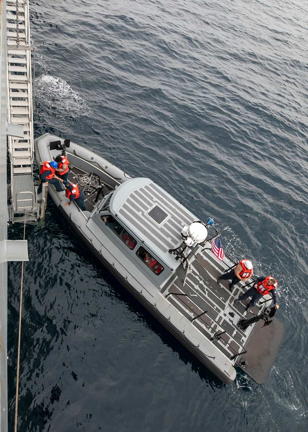 Emory S. Land conducts boat operations while anchored in Andaman Sea