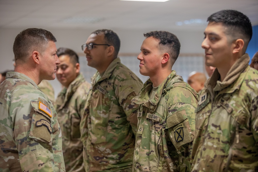 Lt. Gen. Joseph A. Ryan awards coins to 10th Mountain Soldiers during Combined Resolve 25-1