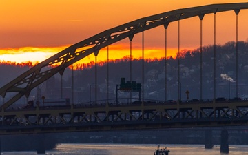 Sunfire and Ice: Towboats navigate through frozen rivers during Pittsburgh sunrise