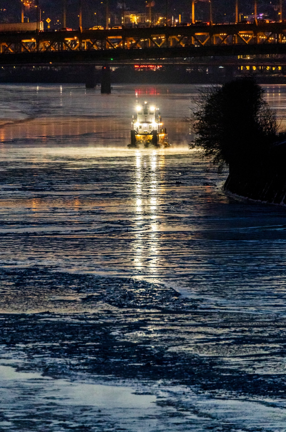 Sunfire and Ice: Towboats navigate through frozen rivers during Pittsburgh sunrise