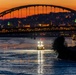 Sunfire and Ice: Towboats navigate through frozen rivers during Pittsburgh sunrise