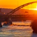 Sunfire and Ice: Towboats navigate through frozen rivers during Pittsburgh sunrise