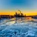 Sunfire and Ice: Towboats navigate through frozen rivers during Pittsburgh sunrise