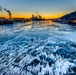 Sunfire and Ice: Towboats navigate through frozen rivers during Pittsburgh sunrise