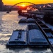 Sunfire and Ice: Towboats navigate through frozen rivers during Pittsburgh sunrise