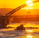 Sunfire and Ice: Towboats navigate through frozen rivers during Pittsburgh sunrise