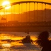 Sunfire and Ice: Towboats navigate through frozen rivers during Pittsburgh sunrise