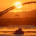 Sunfire and Ice: Towboats navigate through frozen rivers during Pittsburgh sunrise