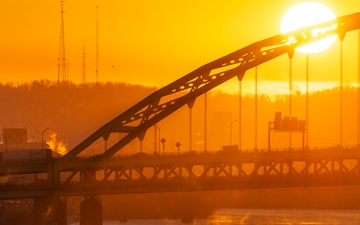 Sunfire and Ice: Towboats navigate through frozen rivers during Pittsburgh sunrise