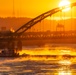 Sunfire and Ice: Towboats navigate through frozen rivers during Pittsburgh sunrise