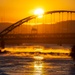 Sunfire and Ice: Towboats navigate through frozen rivers during Pittsburgh sunrise