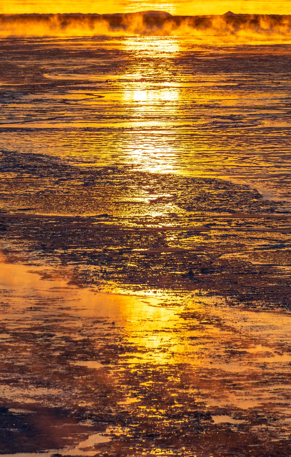 Sunfire and Ice: Towboats navigate through frozen rivers during Pittsburgh sunrise