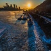 Sunfire and Ice: Towboats navigate through frozen rivers during Pittsburgh sunrise