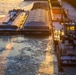 Sunfire and Ice: Towboats navigate through frozen rivers during Pittsburgh sunrise