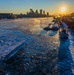 Sunfire and Ice: Towboats navigate through frozen rivers during Pittsburgh sunrise