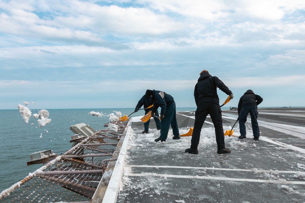 USS Gerald R. Ford (CVN 78) Sailors shovel snow off flight deck