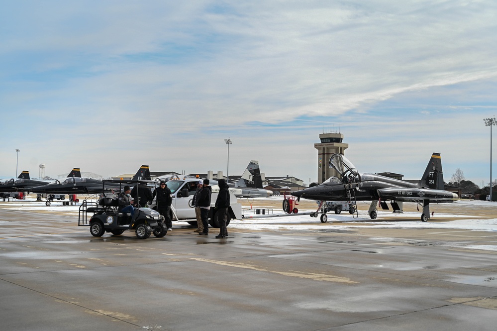 Airmen remove snow, ice for T-38 Talon, F-22 Raptor ops