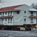 Contractors move first of five World War II-era barracks in 2025