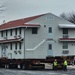 Contractors move first of five World War II-era barracks in 2025