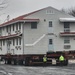 Contractors move first of five World War II-era barracks in 2025