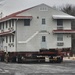 Contractors move first of five World War II-era barracks in 2025