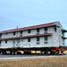 Contractors move first of five World War II-era barracks in 2025