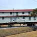 Contractors move first of five World War II-era barracks in 2025