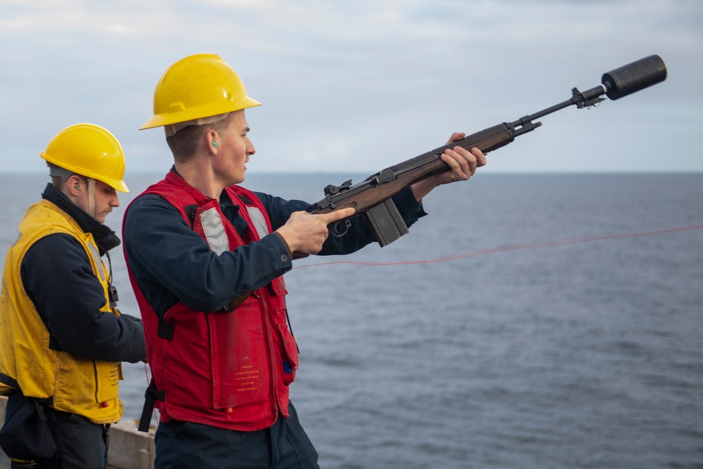 A Nimitz Sailor Shoot a Shot Line During a Replenishment-at-Sea