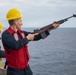 A Nimitz Sailor Shoot a Shot Line During a Replenishment-at-Sea