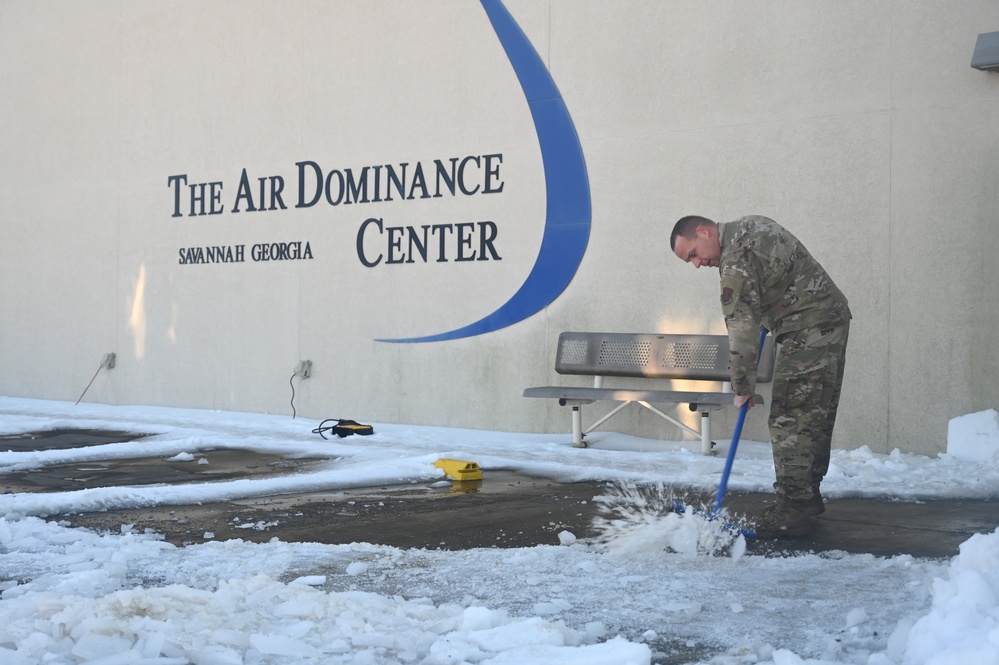 Clearing snow off the flightline