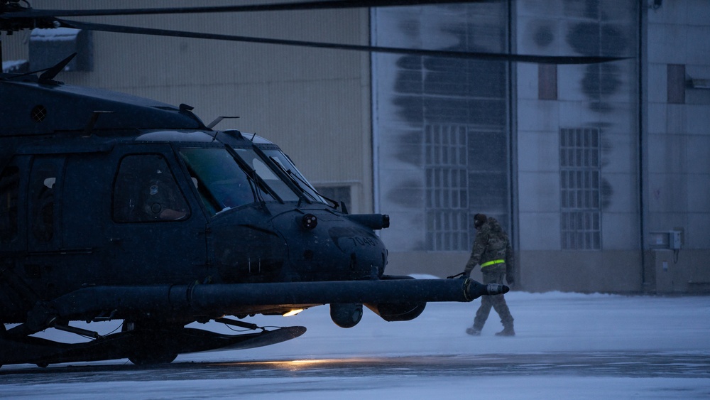 An Alaska Air National Guard HH-60G Pave Hawk helicopter departs Eielson AFB, AK on a routine training flight.