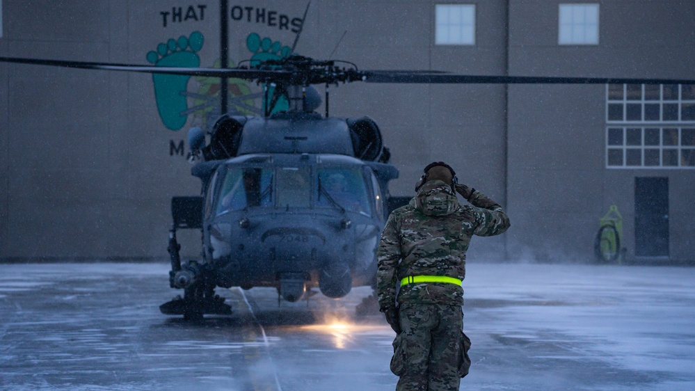 An Alaska Air National Guard HH-60G Pave Hawk helicopter departs Eielson AFB, AK on a routine training flight.