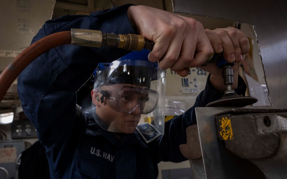 Nimitz Sailor Grinds Down Sheet Metal