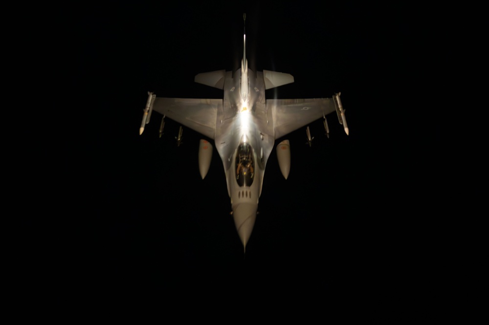 F-16 Fighting Falcons join KC-135 Stratotanker for aerial refueling over USCENTCOM at night