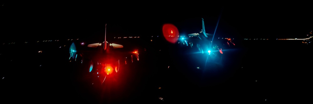 F-16 Fighting Falcons join KC-135 Stratotanker for aerial refueling over USCENTCOM at night