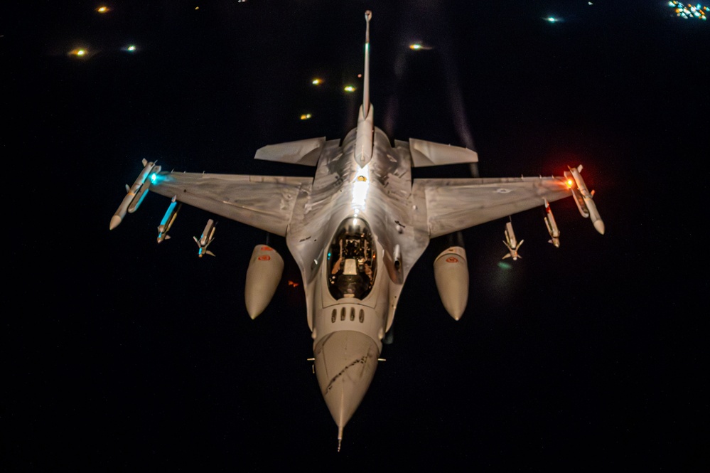 F-16 Fighting Falcons join KC-135 Stratotanker for aerial refueling over USCENTCOM at night