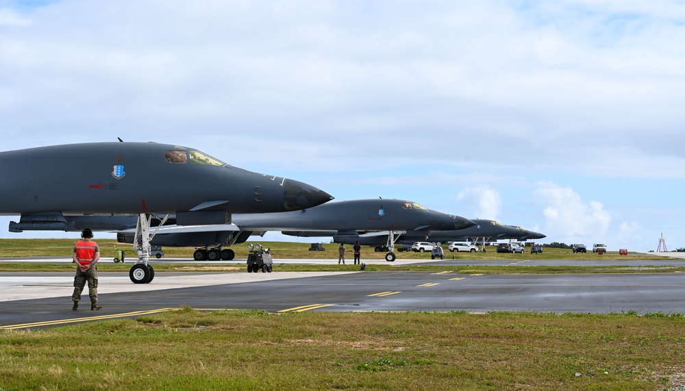 A pair of 34th Expeditionary Bomb Squadron B-1B Lancers perform dual runway takeoff at Andersen Air Force Base during BTF 25-1