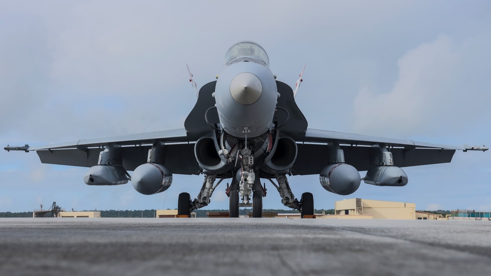 Marine F/A-18 loads Air Force missile in Guam