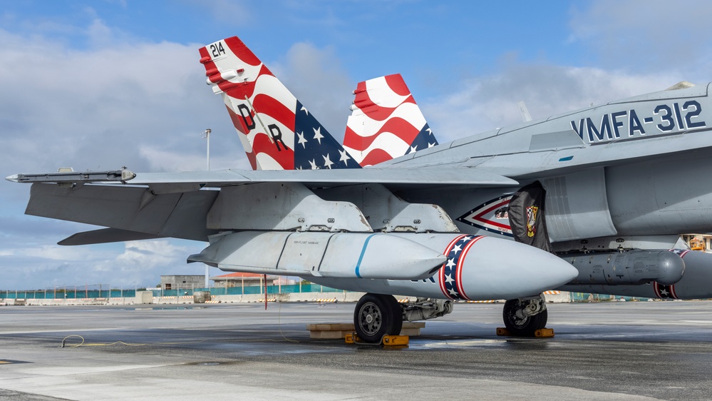 Marine F/A-18 loads Air Force missile in Guam