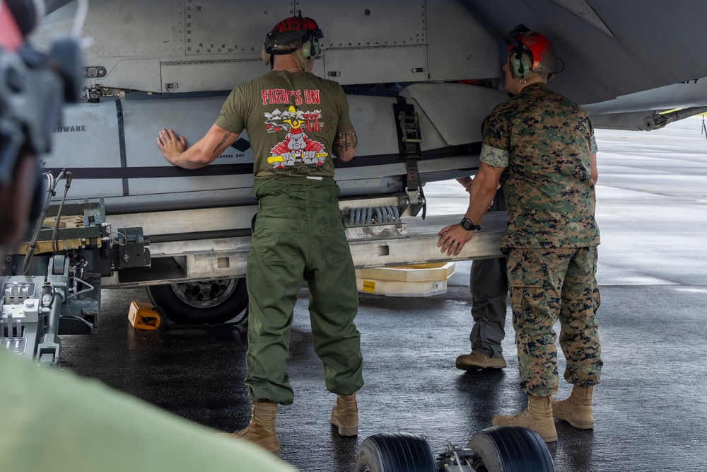 Marine F/A-18 loads Air Force missile in Guam