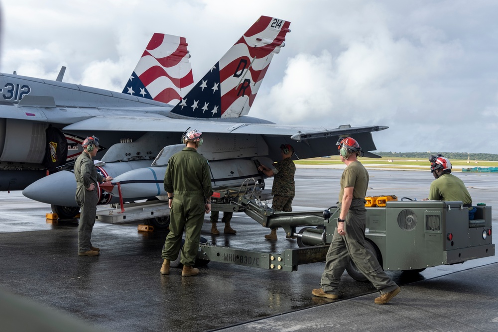 Marine F/A-18 loads Air Force missile in Guam