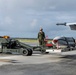 Marine F/A-18 loads Air Force missile in Guam