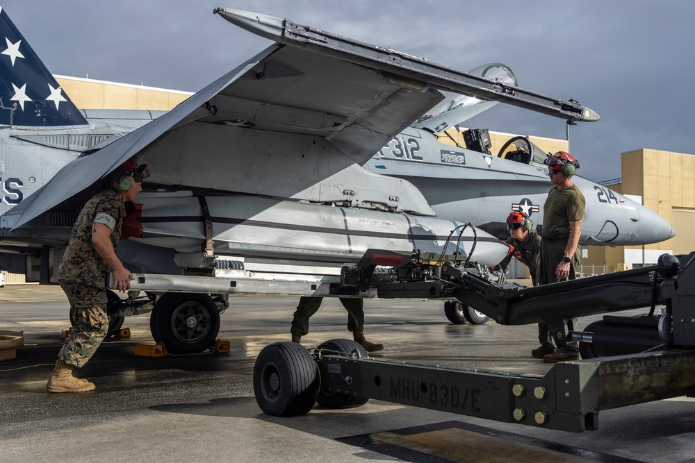 Marine F/A-18 loads Air Force missile in Guam