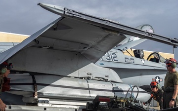 Marine F/A-18 loads Air Force missile in Guam