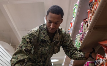 USS Ronald Reagan (CVN 76) Sailors perform retail services