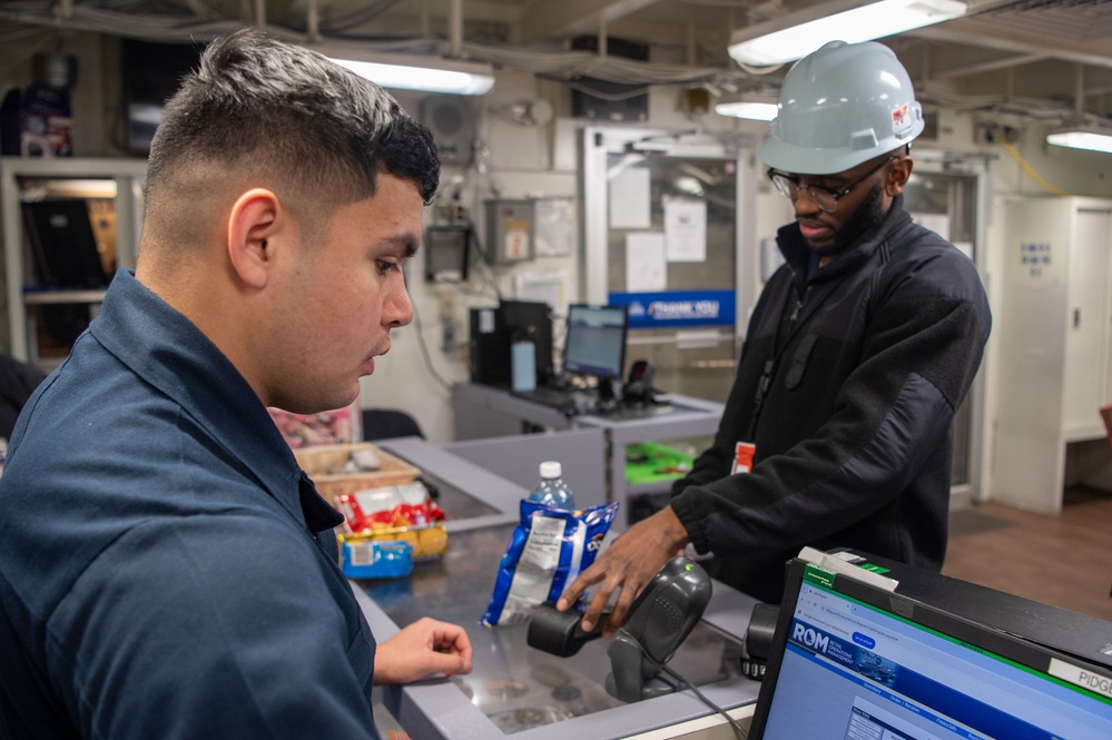 USS Ronald Reagan (CVN 76) Sailors perform retail services