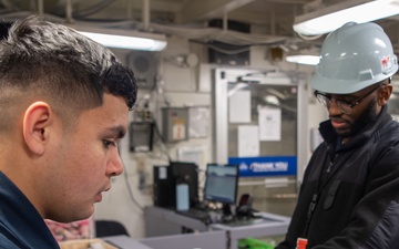 USS Ronald Reagan (CVN 76) Sailors perform retail services