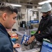 USS Ronald Reagan (CVN 76) Sailors perform retail services